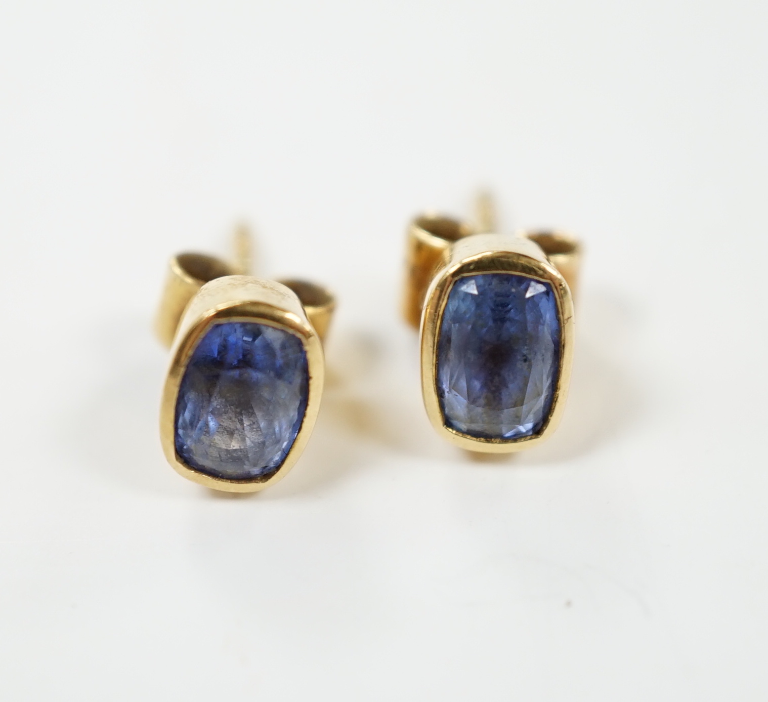 A pair of 750 yellow metal and single stone Ceylon sapphire set ear studs, 7mm, gross weight 2.9 grams.